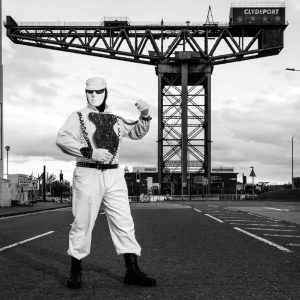 Robert the Robot Glasgow standing beneath the Finnieston Crane in a black and white collector print